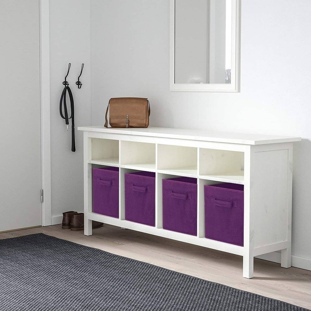 Purple fabric storage cube bins with handles inside a white entryway console