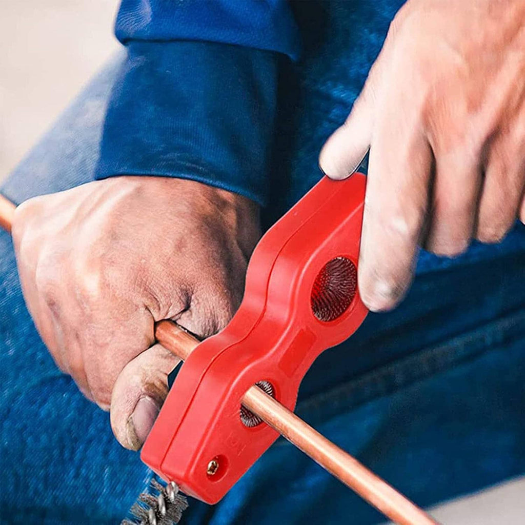 Person using red 4-in-1 copper pipe cleaner brush on copper pipe