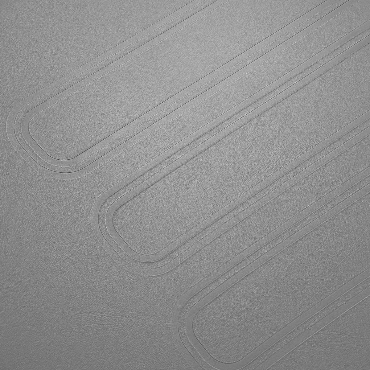 Close-up of gray textured cushion surface with molded lines