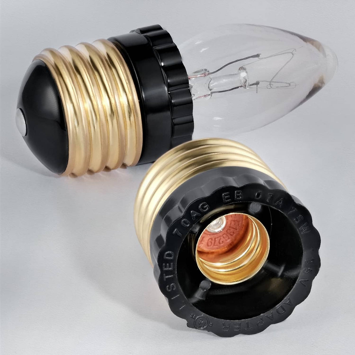 E26 to E12 socket adapter close-up, gold threads, black ring, copper inner contact