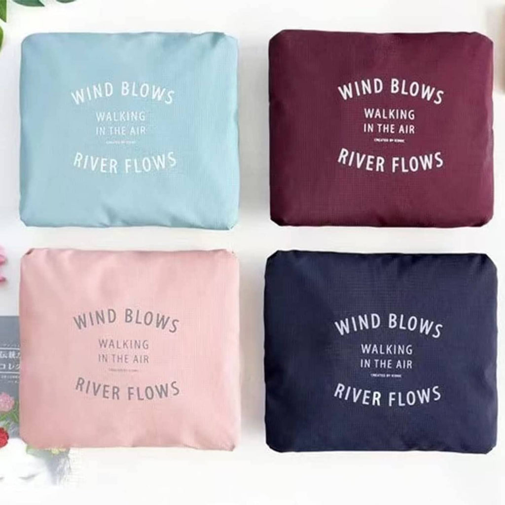 Set of foldable duffel bags in pastel blue, burgundy, blush pink, and navy