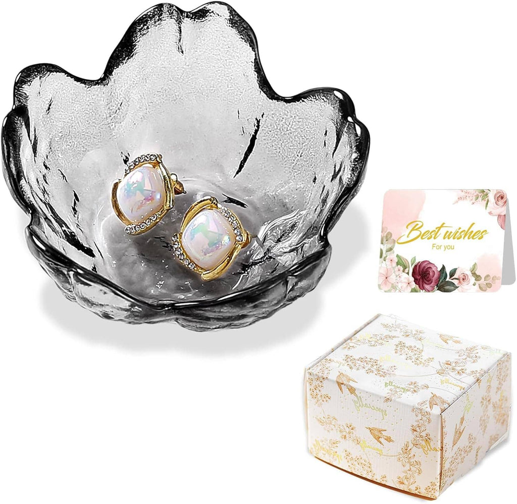 Scalloped glass trinket dish with two gold-tone opal stud earrings, shown on display