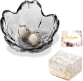 Scalloped glass trinket dish with two gold-tone opal stud earrings, shown on display