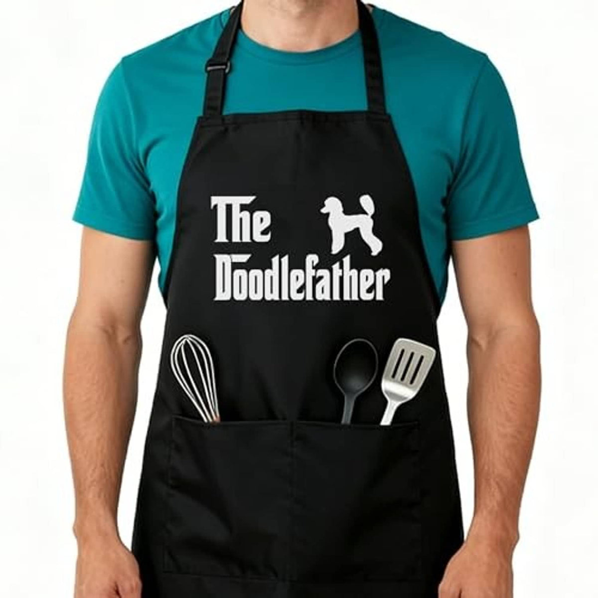 Black kitchen apron with adjustable neck strap; “The Doodlefather” logo and utensil graphic