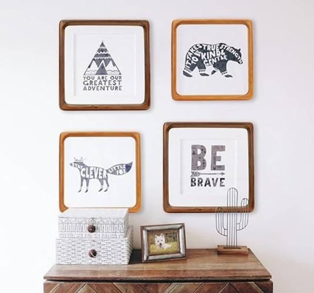 Small square walnut wood picture frames arranged on a tabletop display
