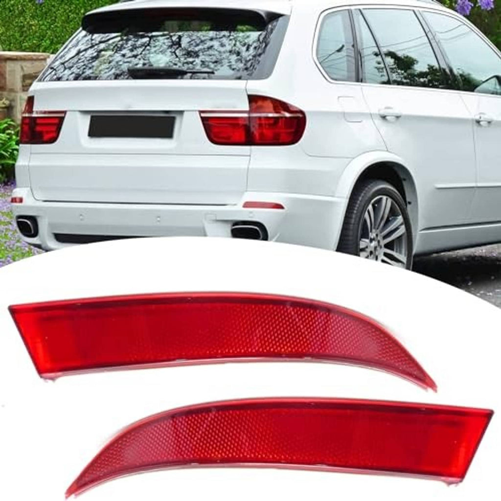 Red rear bumper reflector lenses near the rear of a white SUV