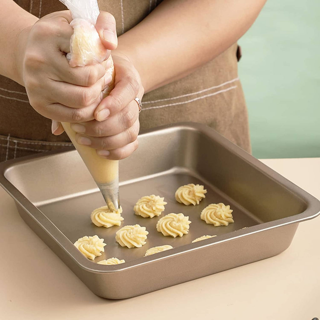 Tipless piping bag squeezing frosting into a baking tray, disposable 12-inch bag