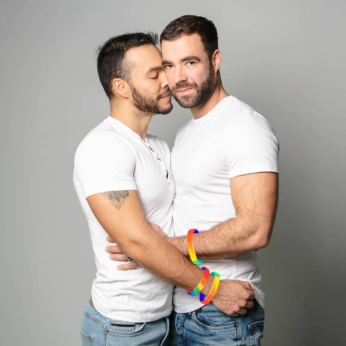 Rainbow striped wristbands on two people standing close together