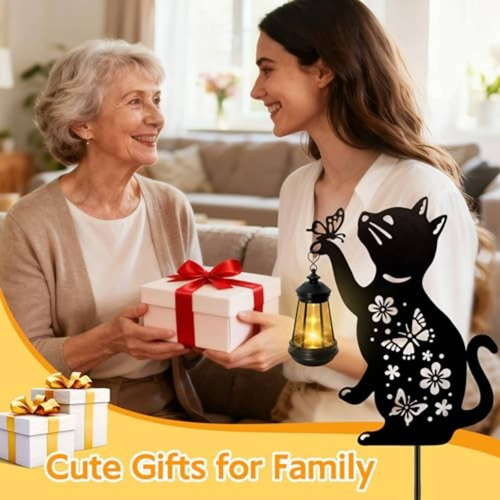 Black cat solar hanging lantern near a gift box, shown indoors