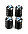 Set of four black tire valve stem caps with BMW blue-and-white logo centers