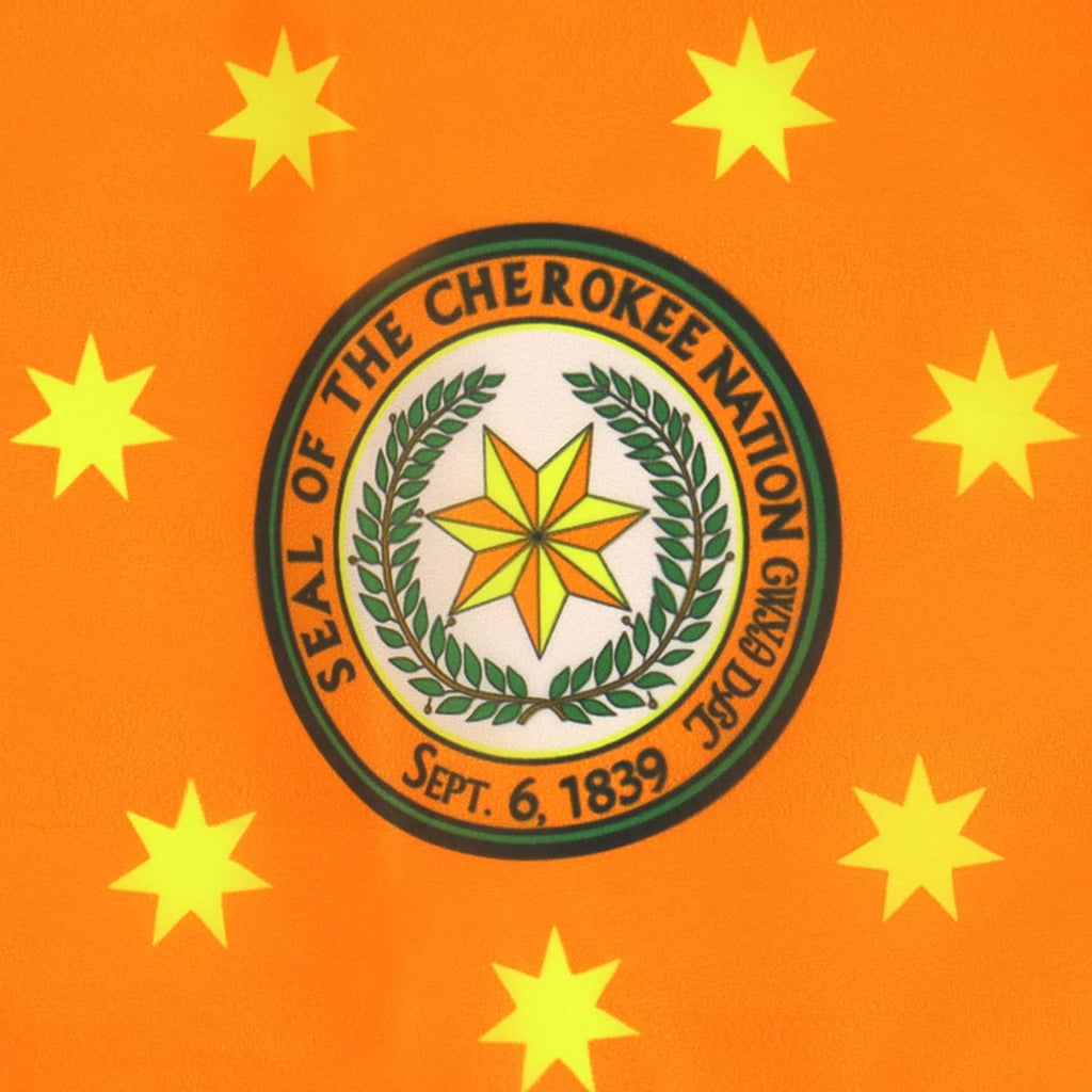 Orange Cherokee Nation flag close-up: circular seal with laurel and yellow stars