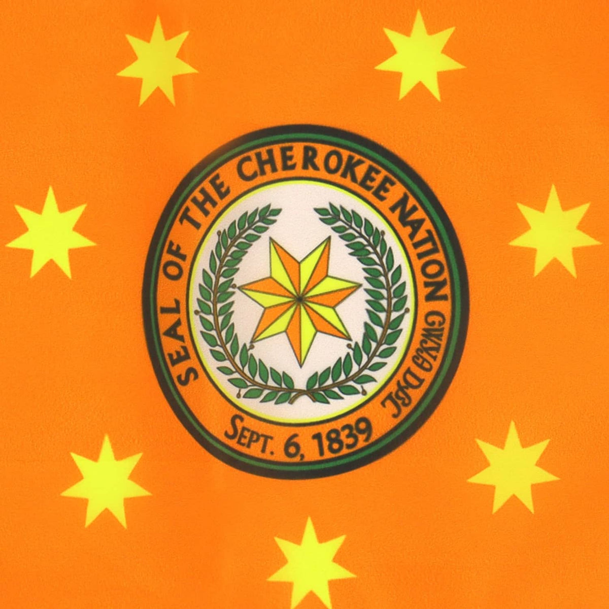 Orange Cherokee Nation flag close-up: circular seal with laurel and yellow stars