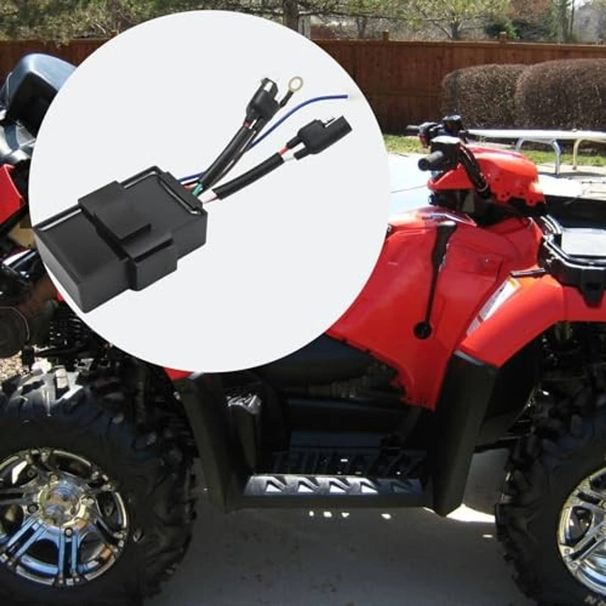 Ignition module box on an ATV body with visible wiring harness close-up