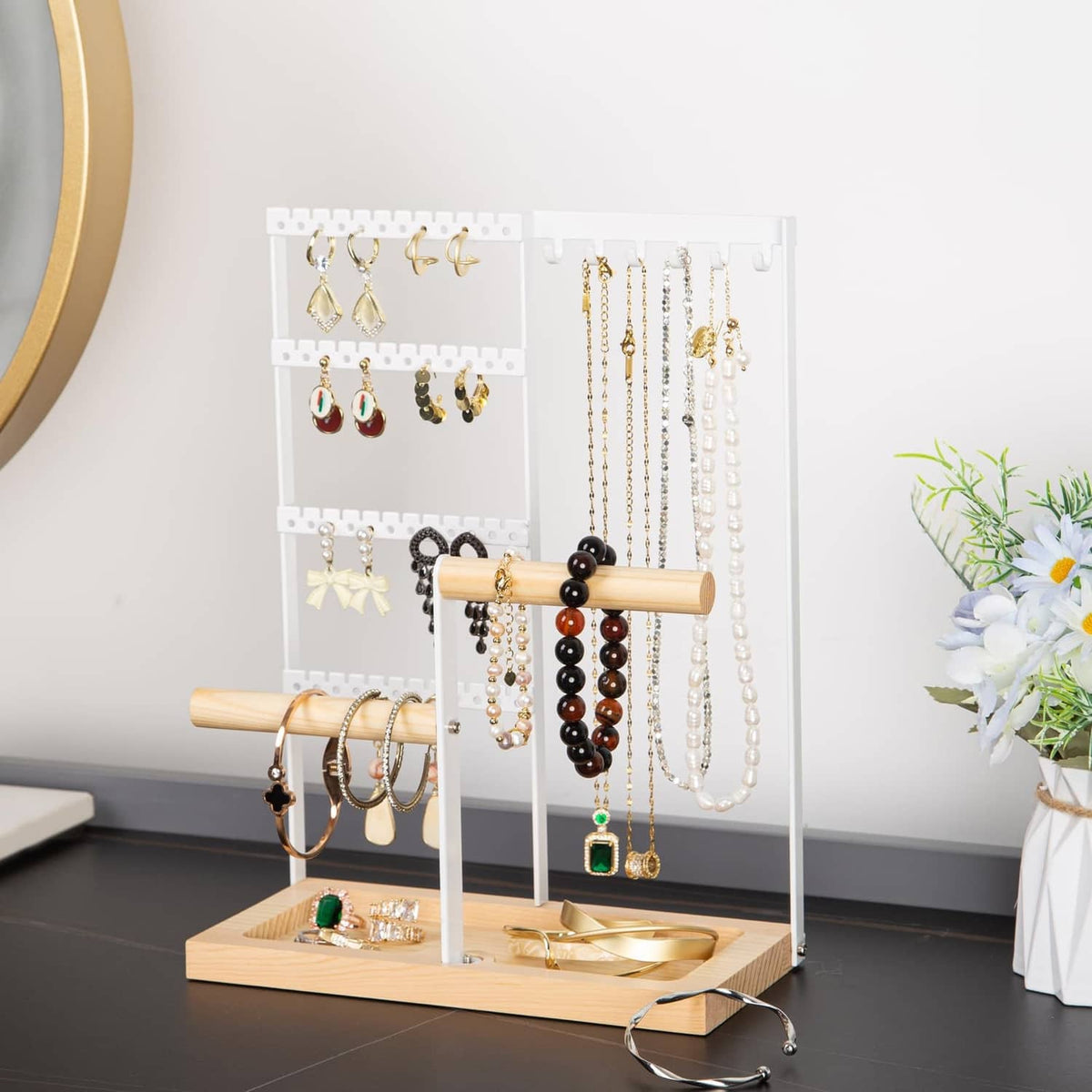 Jewelry organizer stand with white grid and bamboo bar, holding earrings and necklaces