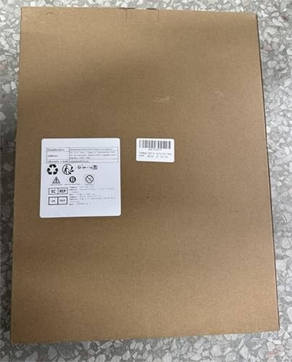 Brown cardboard packaging board with barcode and recycling label