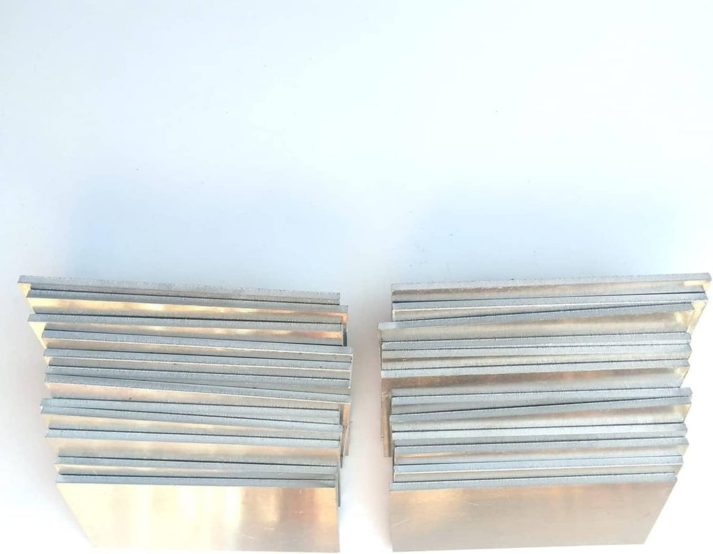 Two stacks of silver aluminum coupon plates, parallel arrangement showing metal layers.