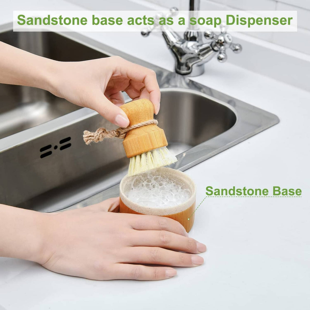 Wooden dish brush with soap dispenser cup beside sink, held by hands