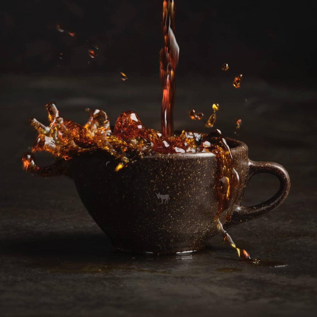 Hot coffee pouring into a mug with sparks, decaf dark roast promotional scene