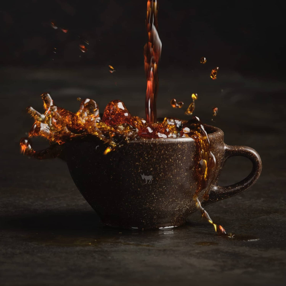 Hot coffee pouring into a mug with sparks, decaf dark roast promotional scene