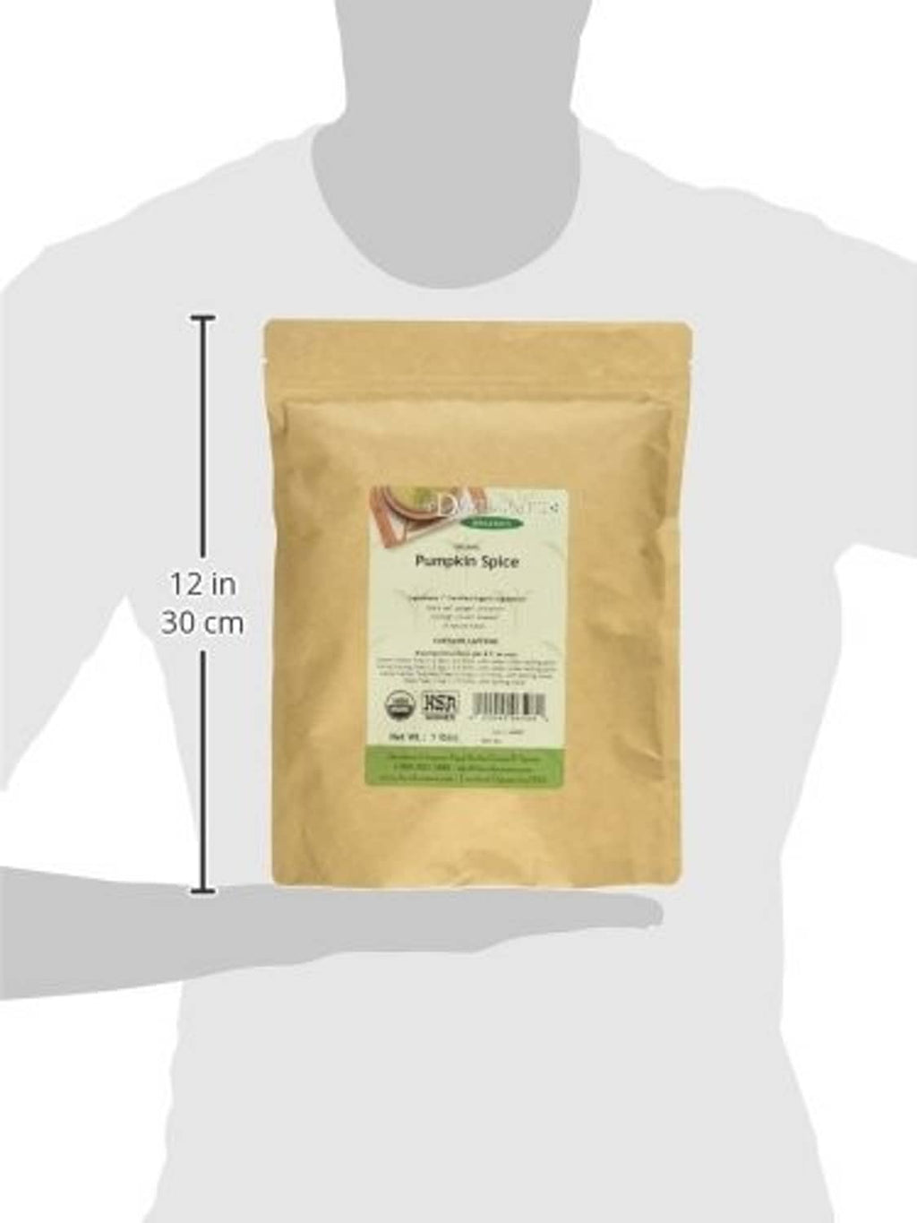 Organic pumpkin spice black tea pouch shown on person, 12 in height