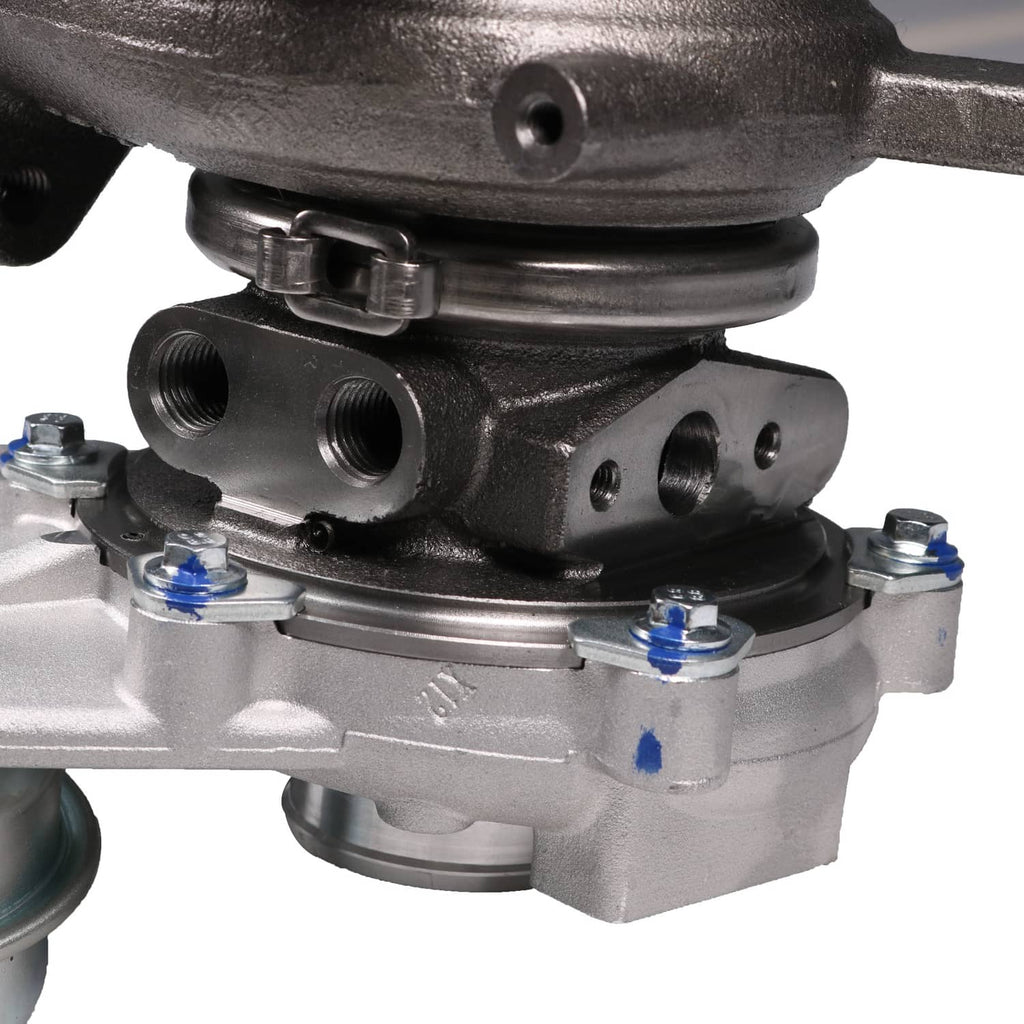 Turbocharger housing close-up with mounting bolts, ports, and gasket flange