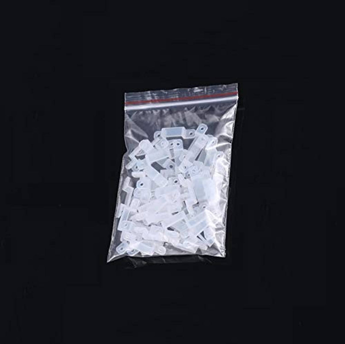 Plastic bag containing white 12mm LED strip mounting brackets, assorted pieces