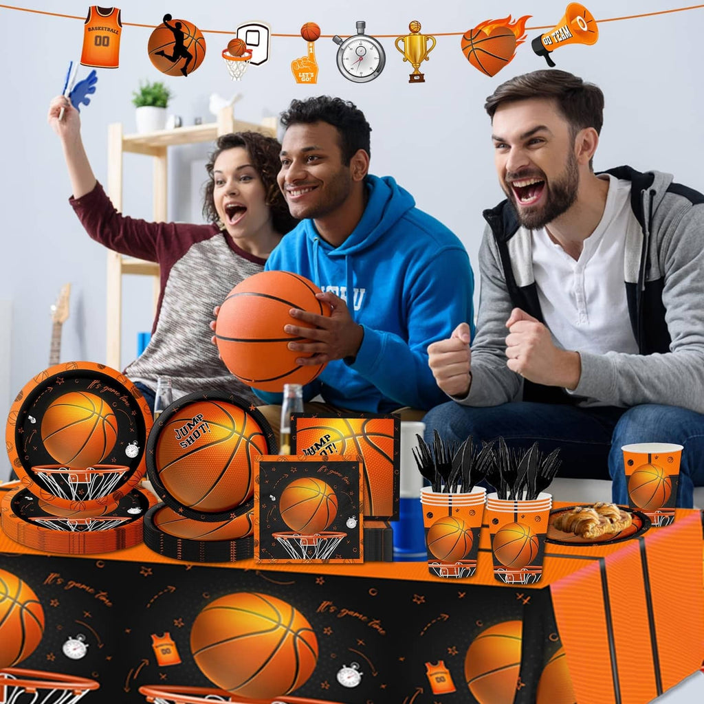 Basketball-themed party table set with black-orange tablecloth, plates, cups, and napkins