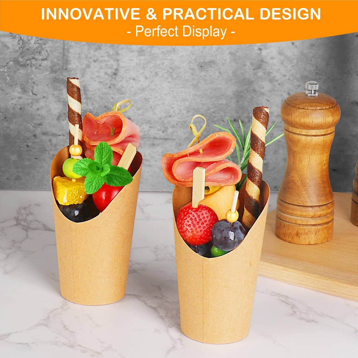 Brown kraft charcuterie cups holding assorted snacks with wooden serving sticks