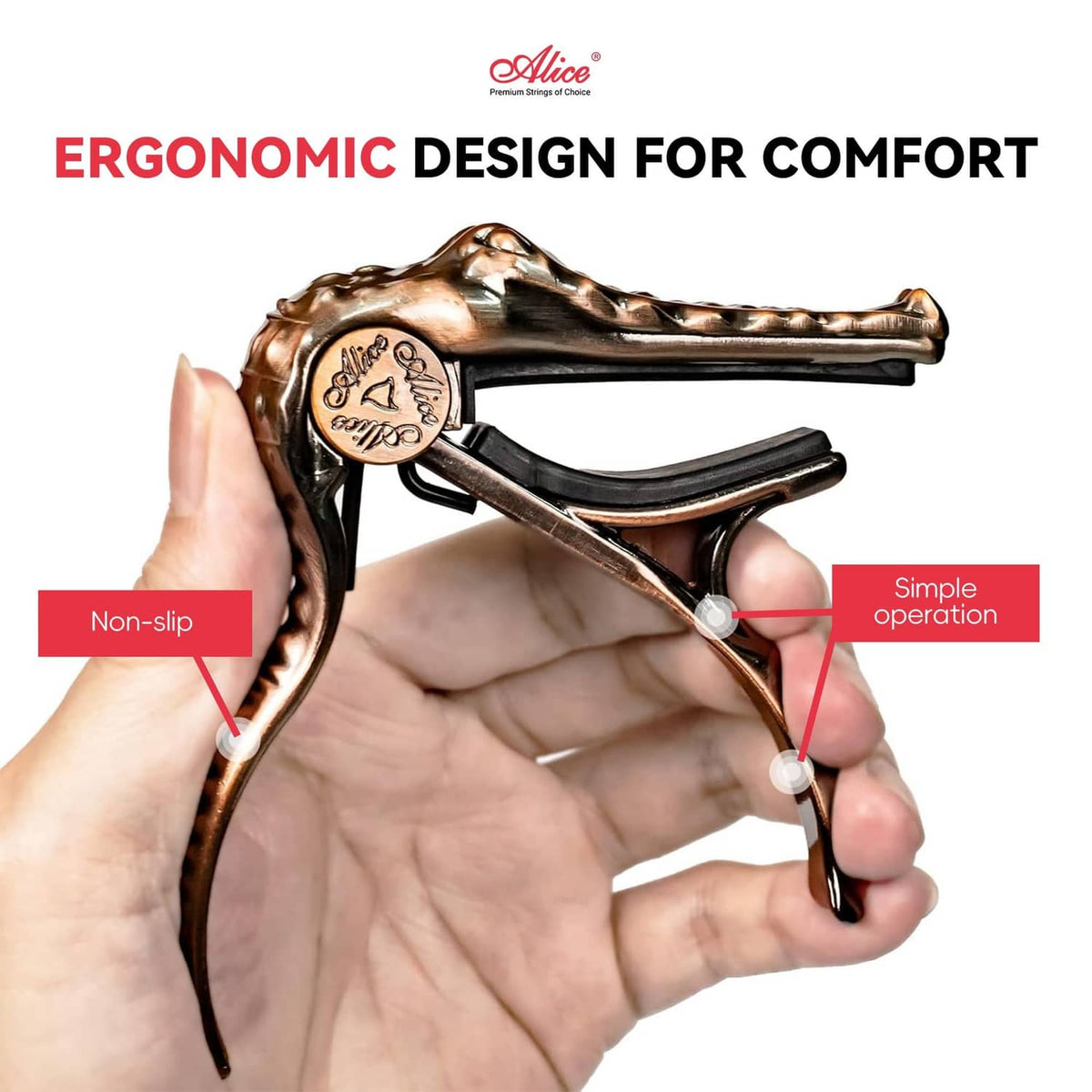Bronze alligator-style guitar capo held in hand, spring clamp design