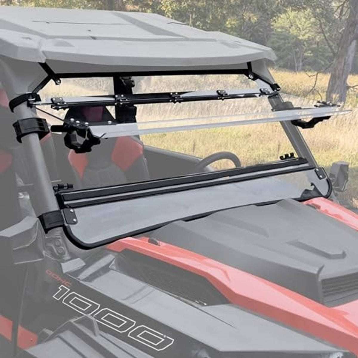 Clear flip-up windshield panel with black brackets on UTV