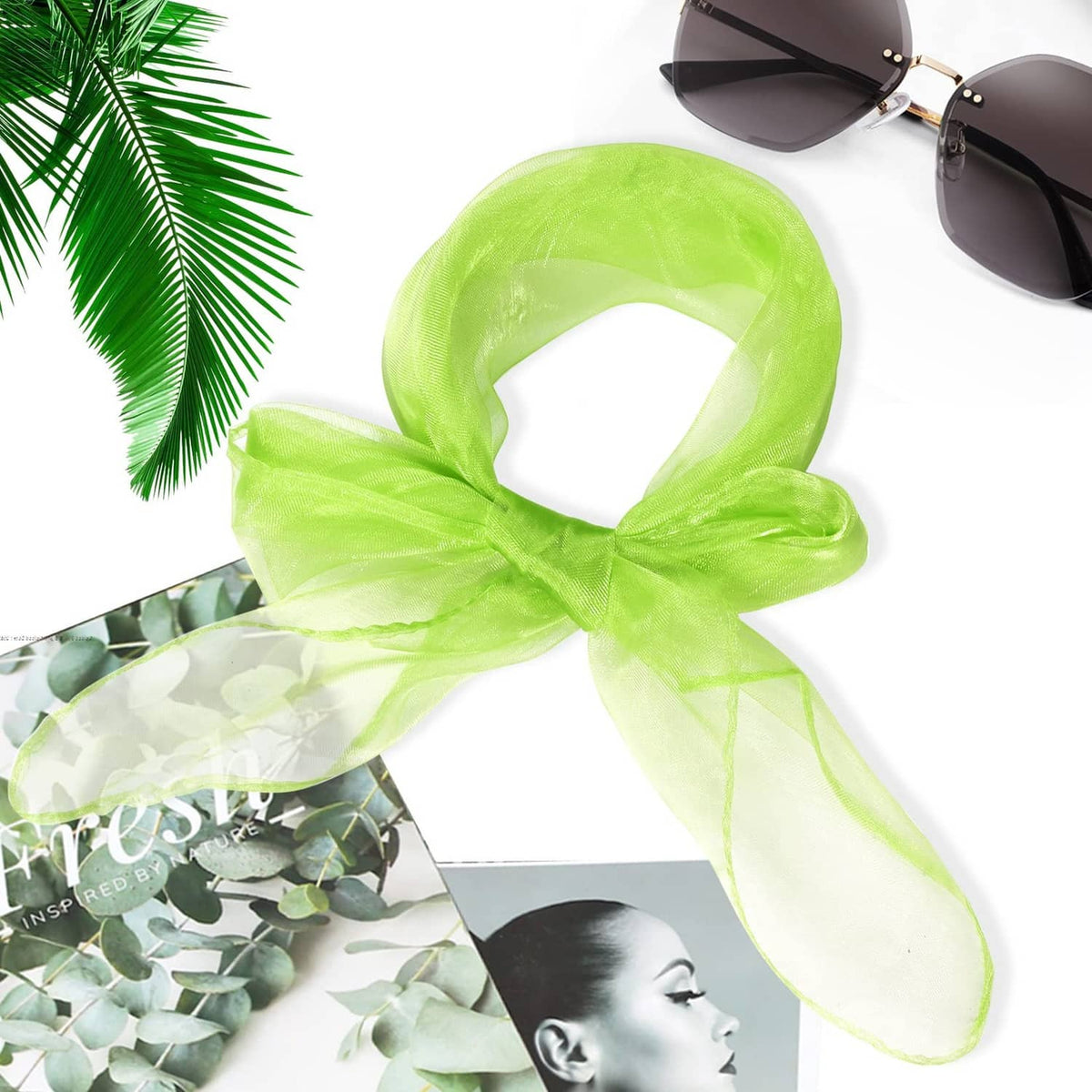 Neon green sheer silk dance scarf tied in a loose knot, flowing edges