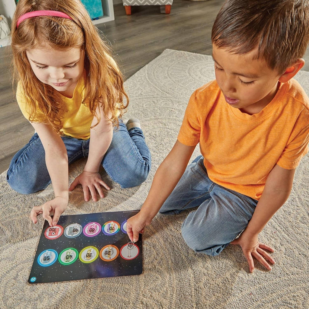 Numbered activity board with circular dials, used by children to match cube values