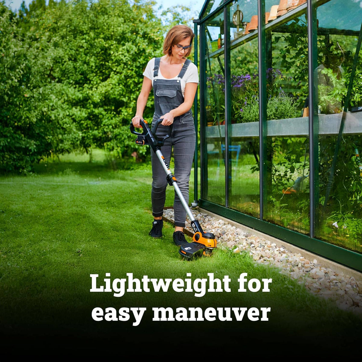 Cordless string trimmer being used beside garden edging for trimming and clean lines