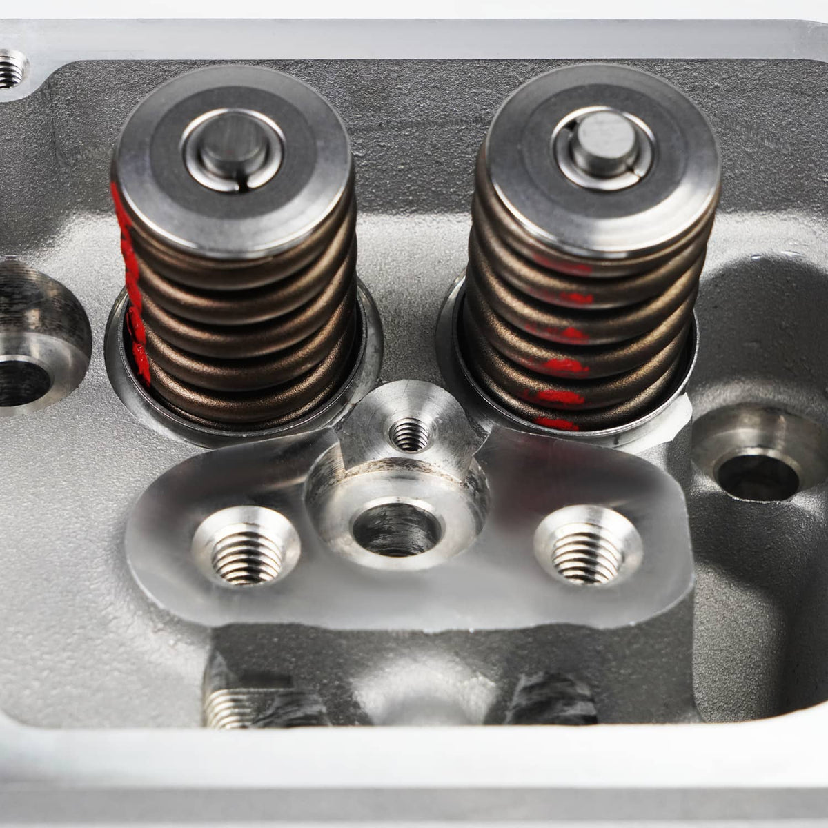 Close-up of aluminum cylinder head valve springs and threaded holes