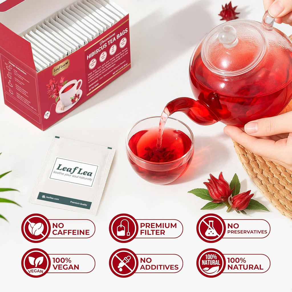 Hibiscus tea bags box with brewed red tea in clear teapot and cup