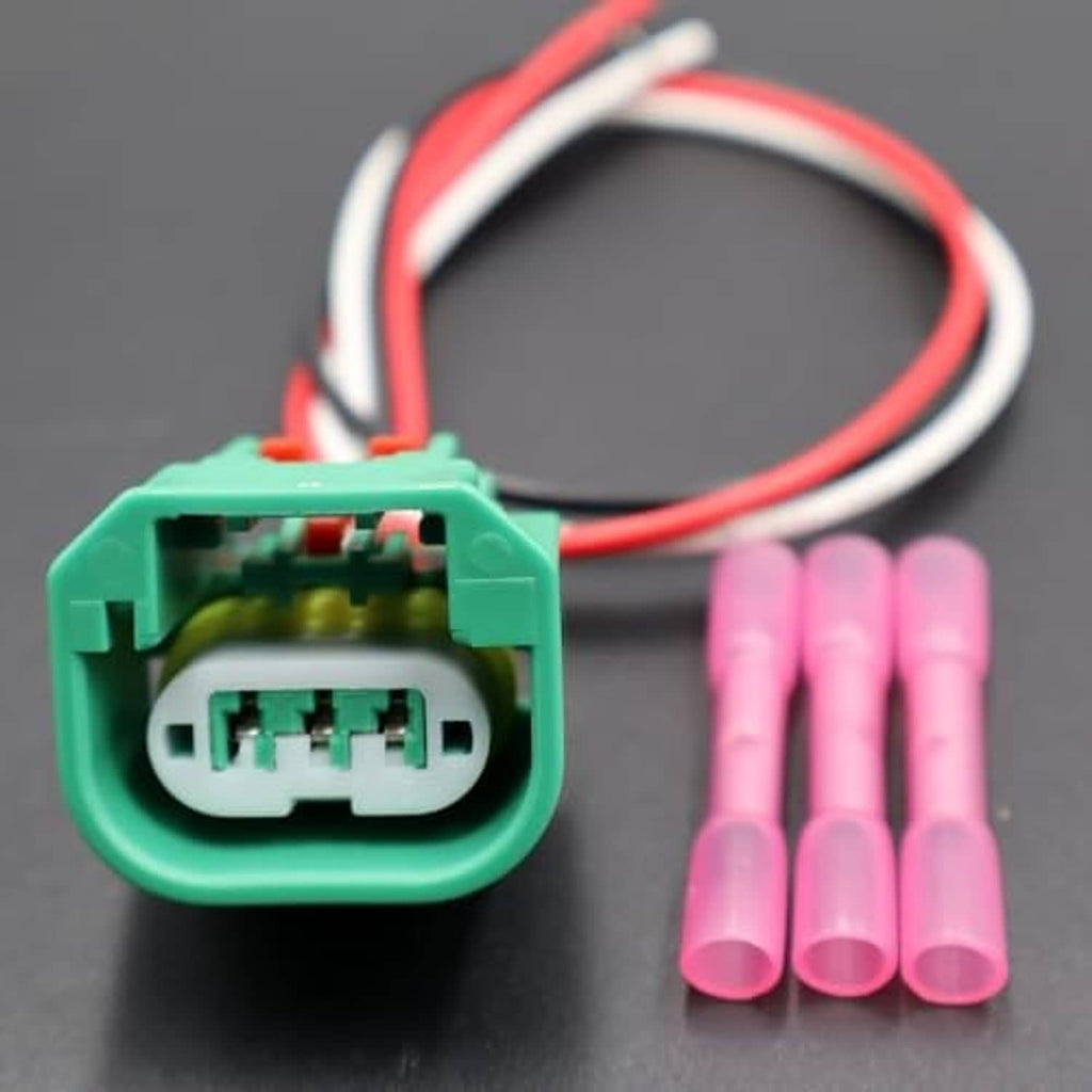 Green headlight connector with red/black wires and pink terminal pin connectors