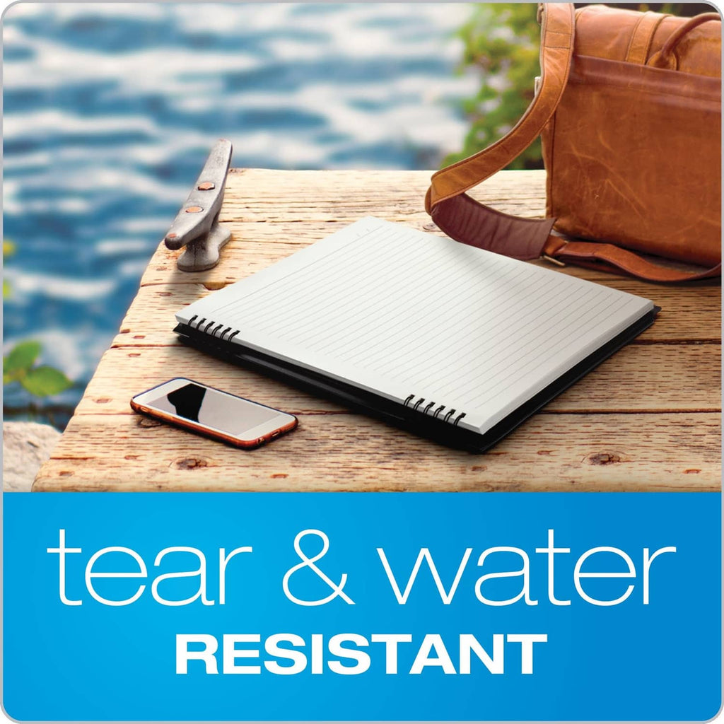 Lined spiral notebook on a wooden surface with pen and phone nearby