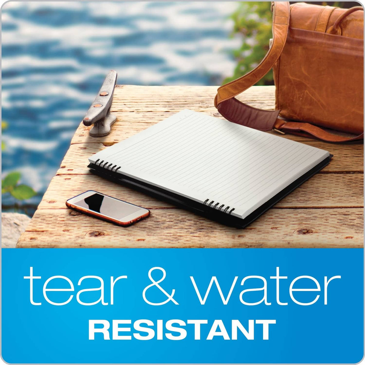 Lined spiral notebook on a wooden surface with pen and phone nearby