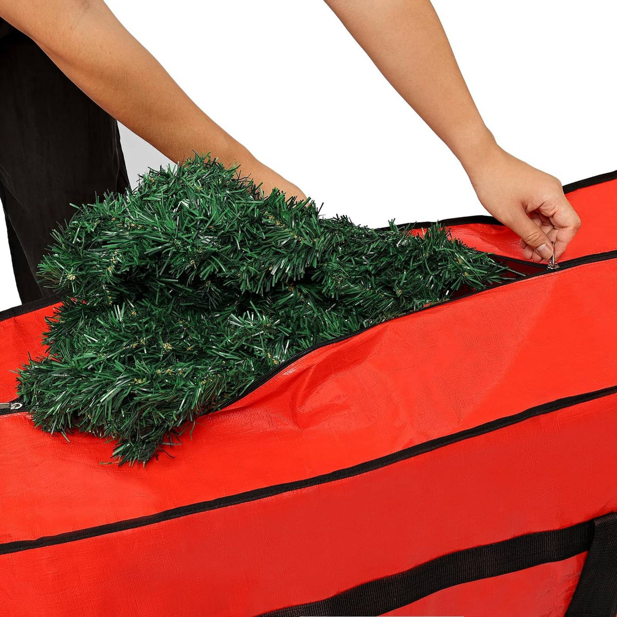 Red Christmas tree storage bag with open top, securing an artificial tree inside