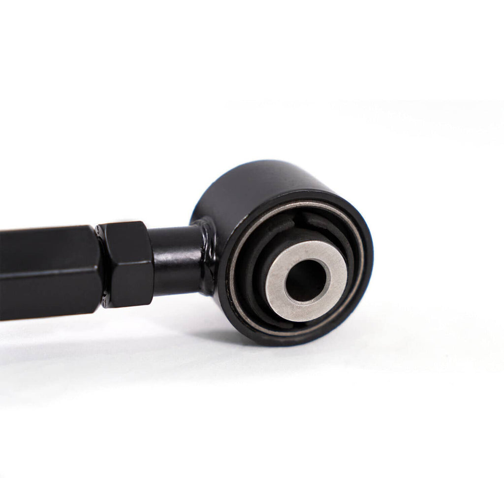 Close-up of black control arm bushing with metal center ring