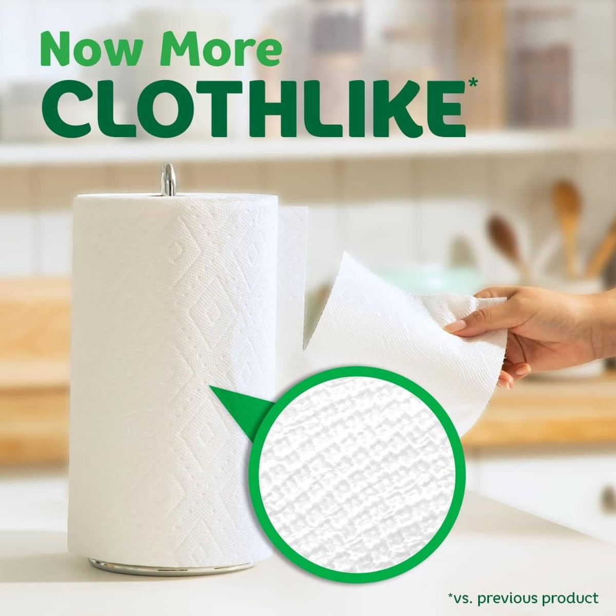 Paper towel roll dispensing white sheets held by hand