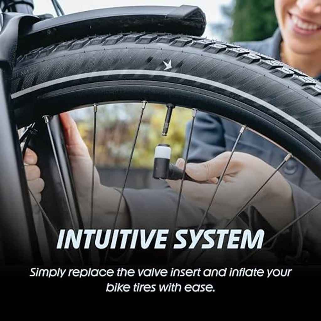 Bike tire with two valve inserts installed and an inflation nozzle at the valves