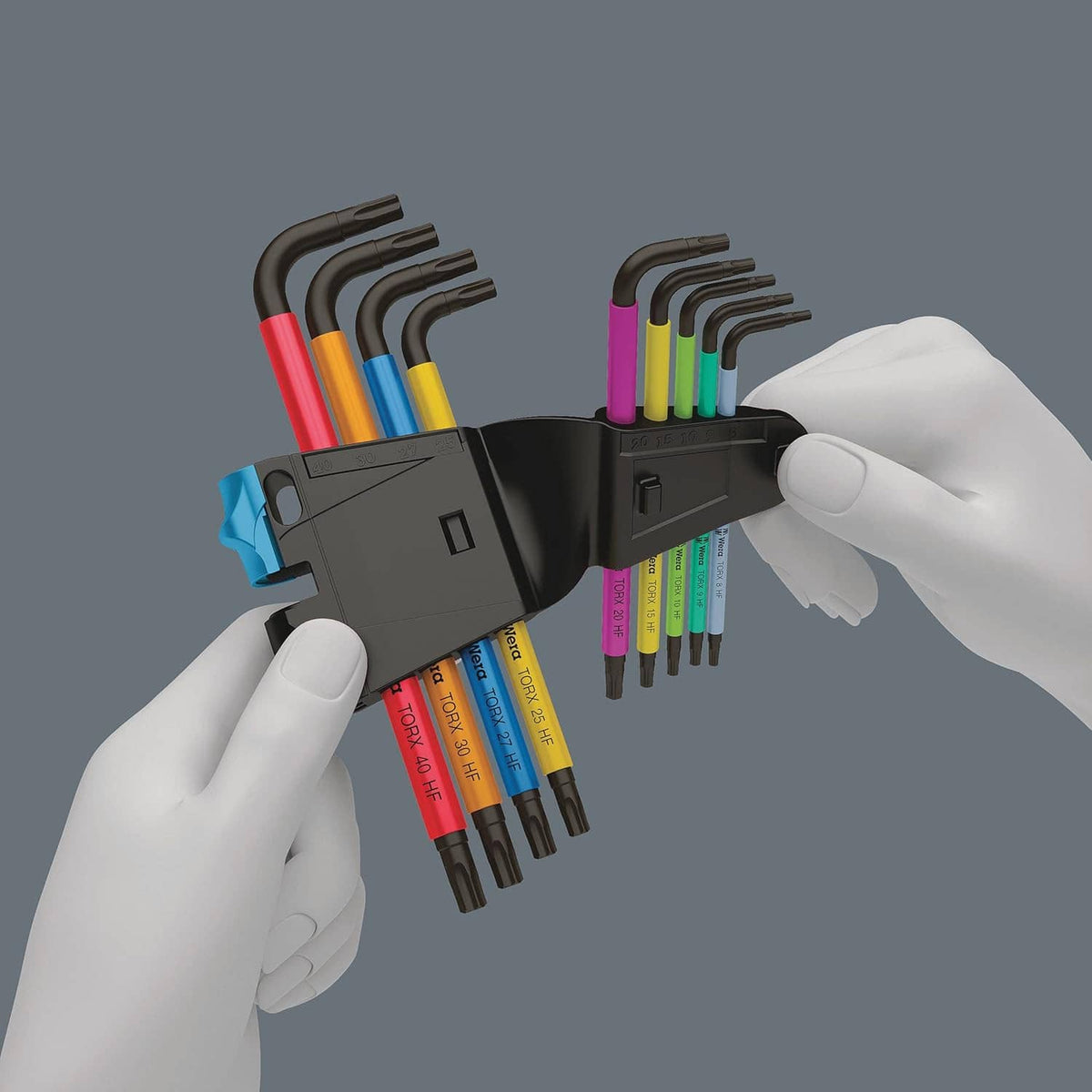 Torx L-key set holder with multicolour L keys held by white-gloved hands