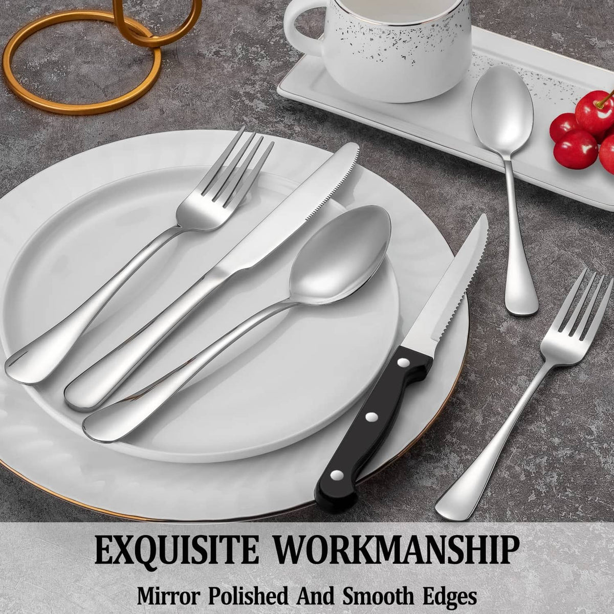Stainless steel cutlery on a plate, including a steak knife with black handle