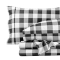 Black-and-white buffalo plaid sheet and pillowcase set, neatly stacked