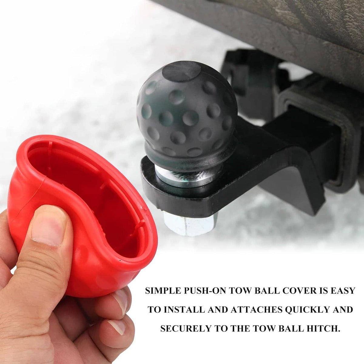 Hand holding a red rubber trailer hitch ball cover with dome top and open underside