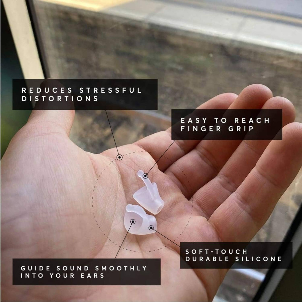 Hand holding small silicone earplugs, flexible curved tips