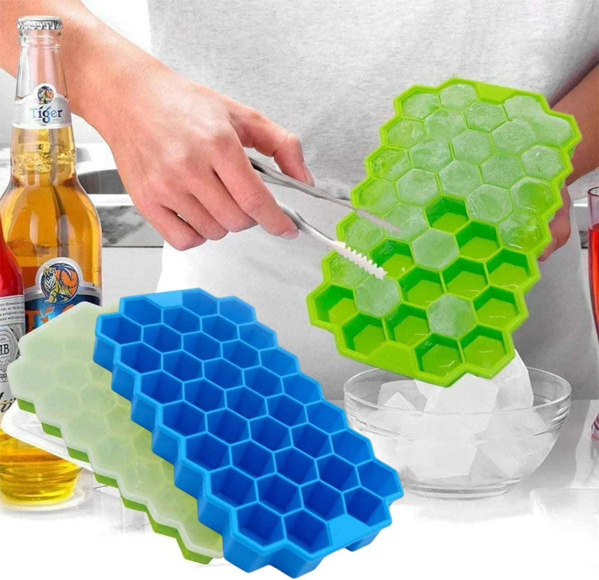 Silicone honeycomb ice cube trays with lid, blue and green hex molds on table