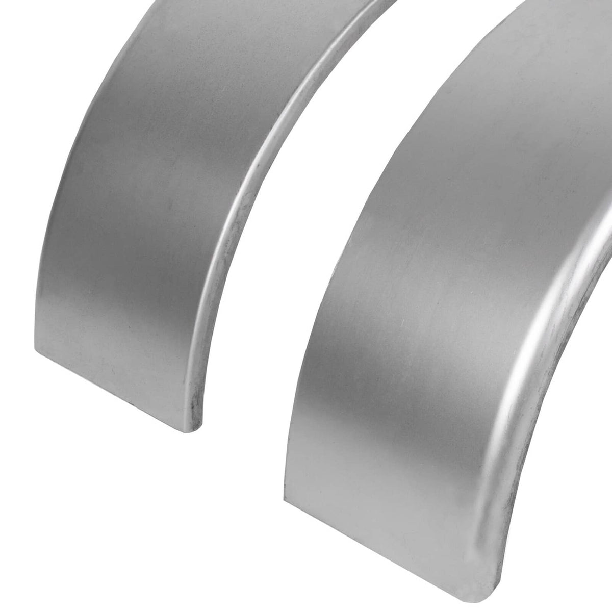 Close-up of two galvanized steel round fenders with smooth curved surfaces