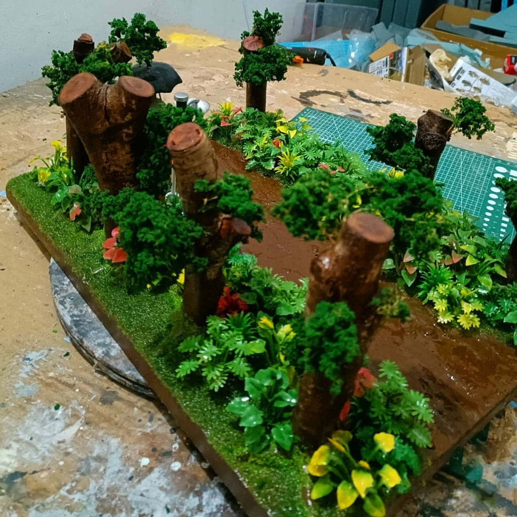Model miniature landscape with assorted green trees and potted plants